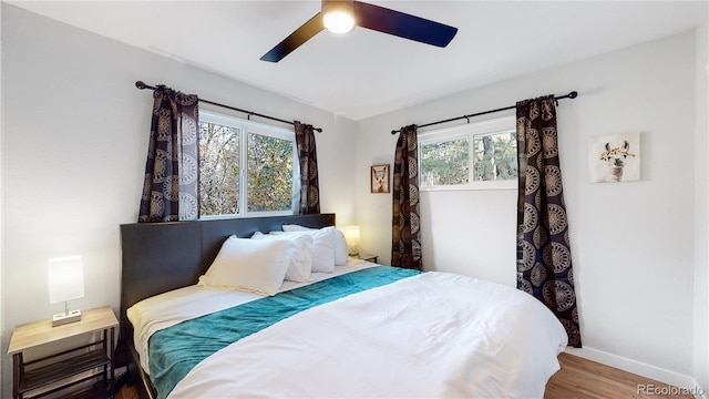 bedroom featuring a ceiling fan, wood finished floors, and baseboards