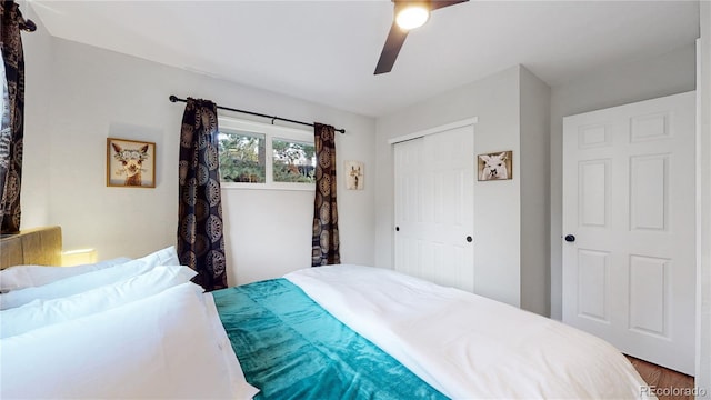 bedroom with wood finished floors, a closet, and ceiling fan