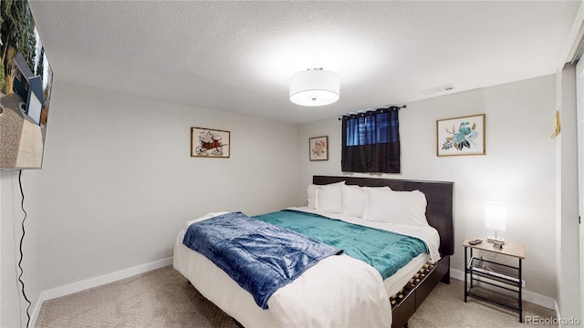 carpeted bedroom featuring visible vents, baseboards, and a textured ceiling