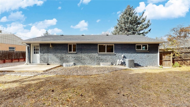 back of house with a patio, cooling unit, fence, and brick siding