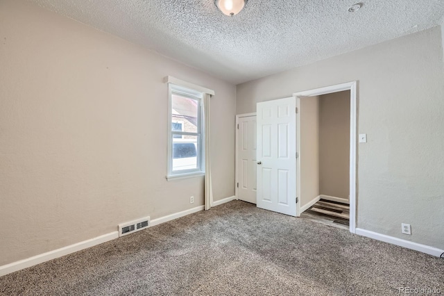 1746 Galena St, Aurora, CO 80010 - unfurnished bedroom with carpet flooring, a textured ceiling, baseboards, and a textured wall