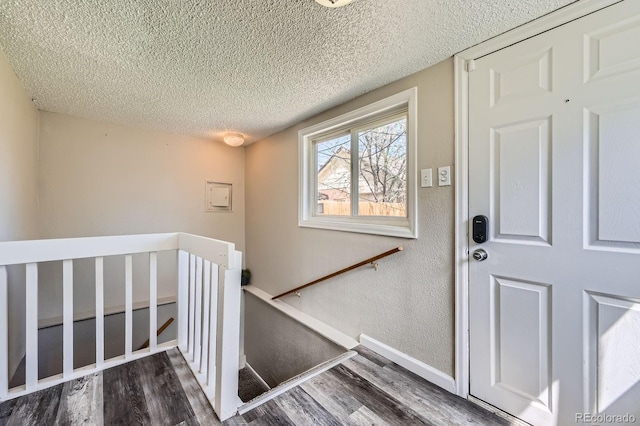 1746 Galena St, Aurora, CO 80010 - stairs featuring a textured ceiling, wood finished floors, and baseboards