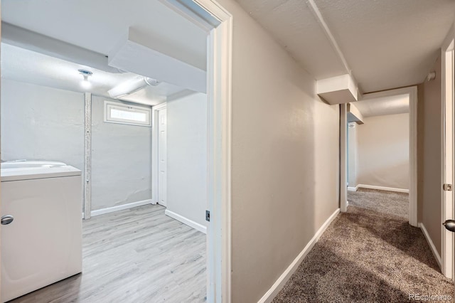1746 Galena St, Aurora, CO 80010 - corridor featuring washer / clothes dryer, baseboards, and light wood-style flooring