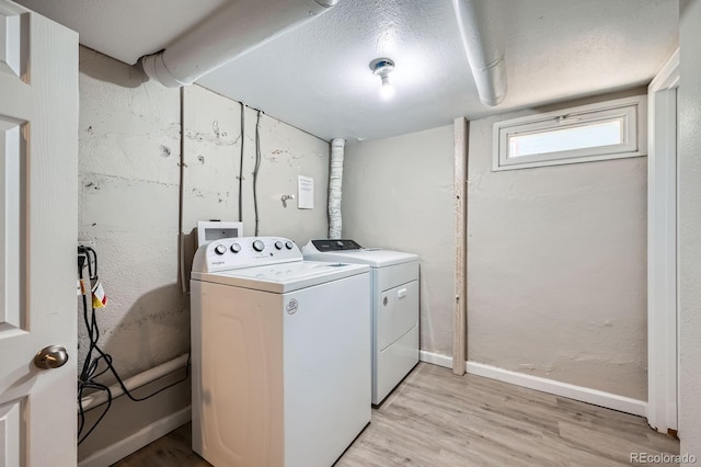 1746 Galena St, Aurora, CO 80010 - clothes washing area featuring washing machine and dryer, light wood-style flooring, and baseboards