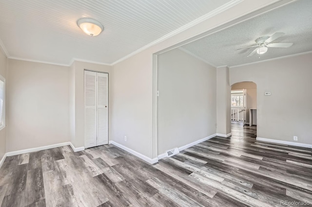 1746 Galena St, Aurora, CO 80010 - empty room featuring arched walkways, wood finished floors, a ceiling fan, baseboards, and crown molding