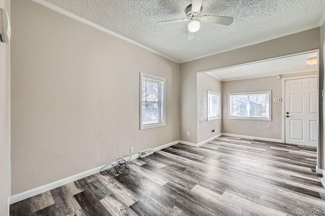 1746 Galena St, Aurora, CO 80010 - spare room featuring a textured ceiling, healthy amount of natural light, crown molding, wood finished floors, and ceiling fan