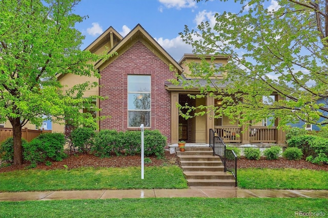 view of front of property with brick siding and stucco siding