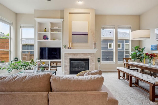 living room with carpet floors and a brick fireplace