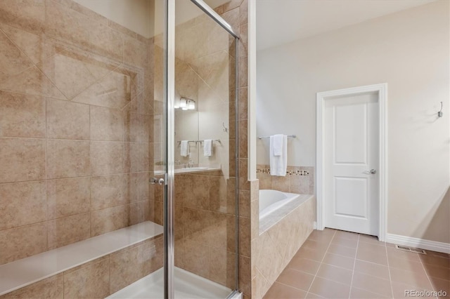 bathroom with a stall shower, tile patterned floors, and a bath
