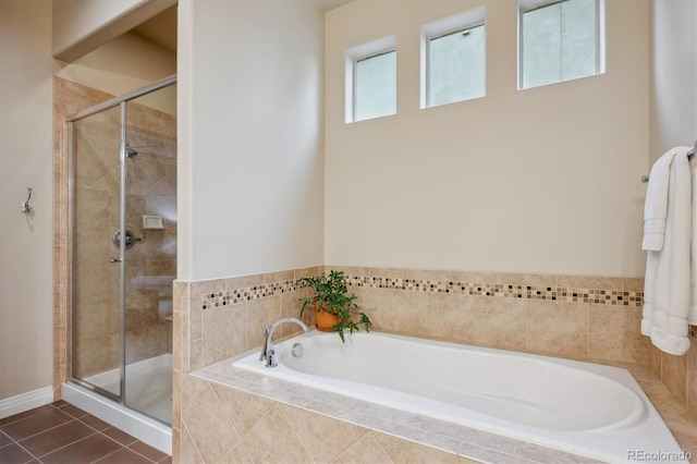 full bathroom with a stall shower, a bath, and tile patterned flooring