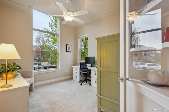 home office with a ceiling fan, light carpet, and baseboards
