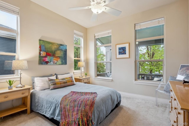 carpeted bedroom featuring baseboards and ceiling fan