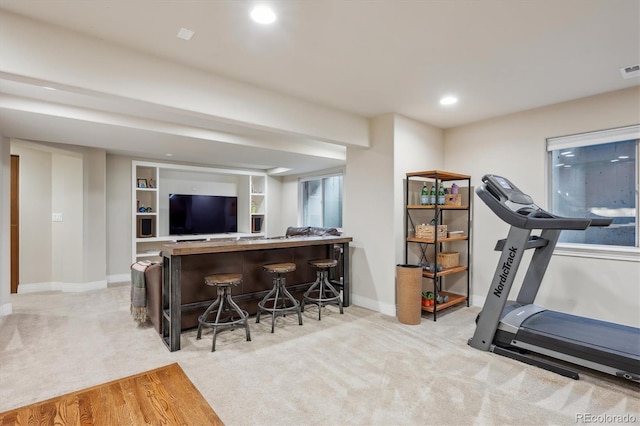 workout room with a dry bar, light colored carpet, baseboards, and recessed lighting