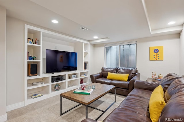 living area with baseboards, carpet floors, recessed lighting, built in shelves, and a raised ceiling