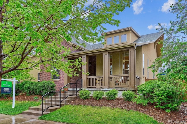 view of front facade with stucco siding and a porch