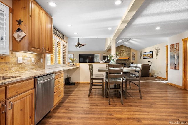 kitchen featuring light stone counters, dishwasher, lofted ceiling with beams, and hardwood / wood-style flooring