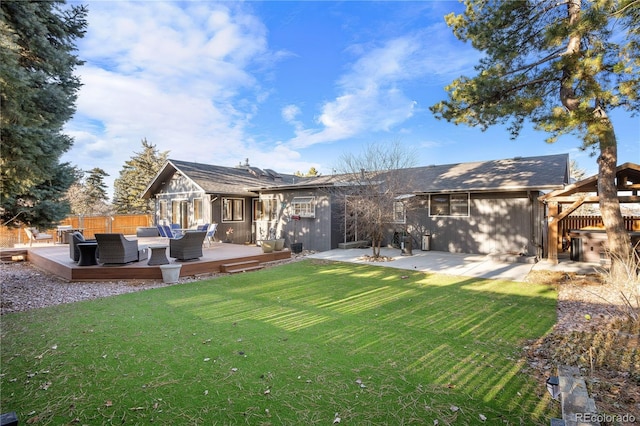 rear view of property featuring a yard and a deck