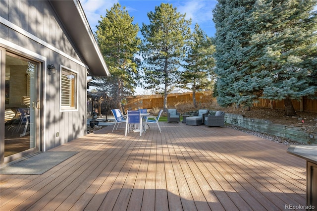 wooden terrace with an outdoor hangout area