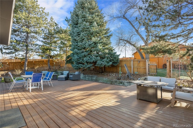 deck with an outdoor living space with a fire pit