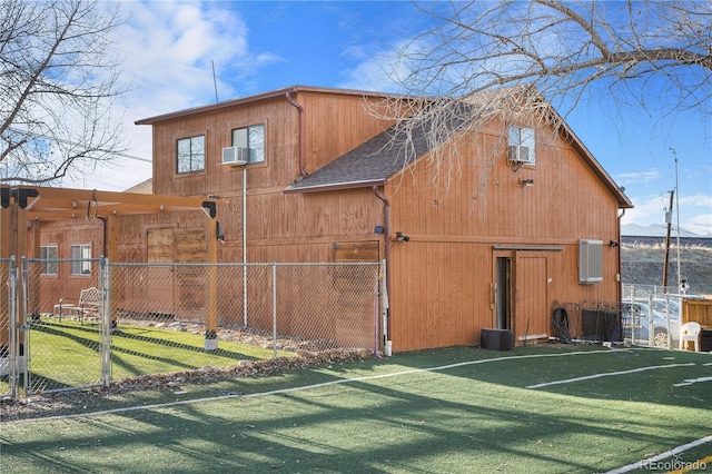 view of outdoor structure featuring cooling unit and a yard