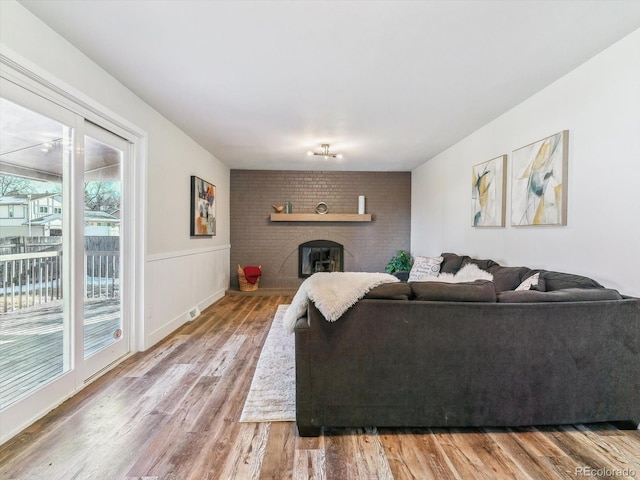 living room featuring a fireplace and wood-type flooring