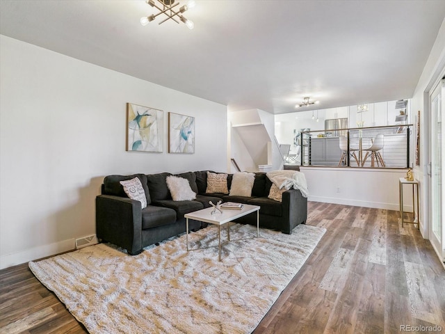 living room featuring hardwood / wood-style floors and a chandelier