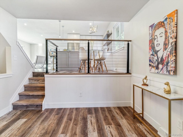 staircase with hardwood / wood-style floors and a healthy amount of sunlight