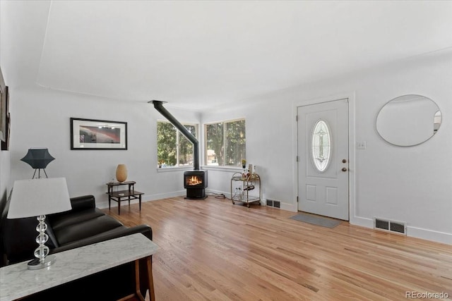 4125 Pierce St, Wheat Ridge, CO 80033 - entryway featuring a wood stove and light wood-type flooring