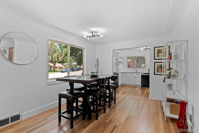 4125 Pierce St, Wheat Ridge, CO 80033 - dining room featuring a chandelier and light wood-type flooring