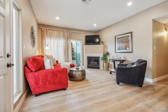 3847 Mossy Rock Dr Unit 104, Highlands Ranch, CO 80126 - living room featuring wood finished floors, baseboards, a tile fireplace, and recessed lighting