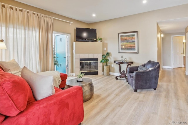 3847 Mossy Rock Dr Unit 104, Highlands Ranch, CO 80126 - living room with wood finished floors, baseboards, recessed lighting, and a fireplace