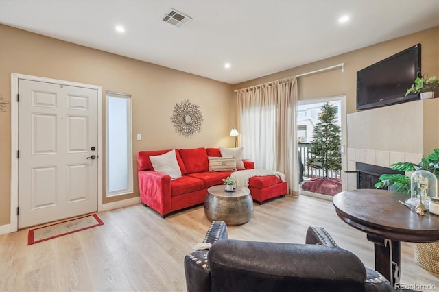 3847 Mossy Rock Dr Unit 104, Highlands Ranch, CO 80126 - living room featuring light wood finished floors, a fireplace, and recessed lighting