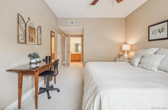 3847 Mossy Rock Dr Unit 104, Highlands Ranch, CO 80126 - bedroom featuring light colored carpet, ensuite bath, and baseboards