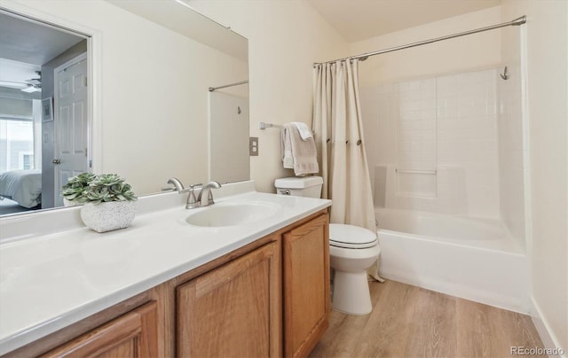 3847 Mossy Rock Dr Unit 104, Highlands Ranch, CO 80126 - bathroom featuring toilet, vanity, wood finished floors, shower / bath combination with curtain, and connected bathroom