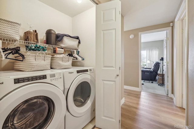 3847 Mossy Rock Dr Unit 104, Highlands Ranch, CO 80126 - washroom with independent washer and dryer, light wood-style flooring, and baseboards