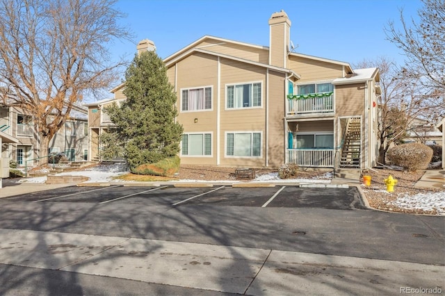 3847 Mossy Rock Dr Unit 104, Highlands Ranch, CO 80126 - view of property featuring uncovered parking and stairs