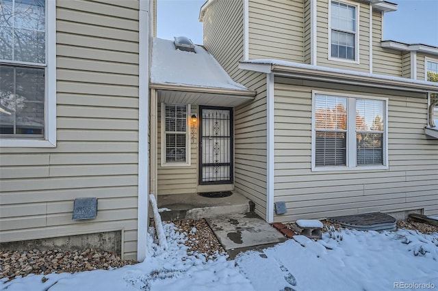 view of snow covered property entrance