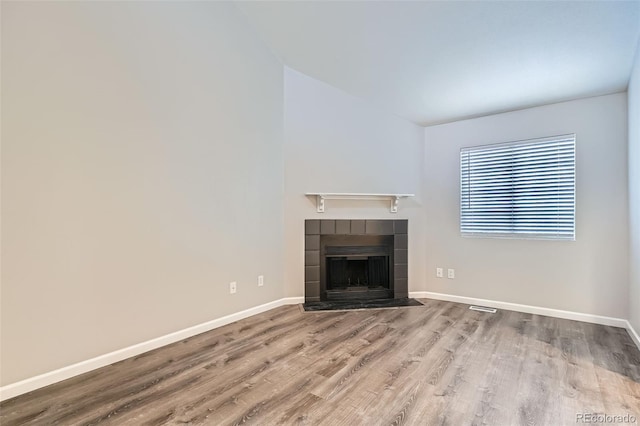 unfurnished living room featuring hardwood / wood-style floors and a fireplace