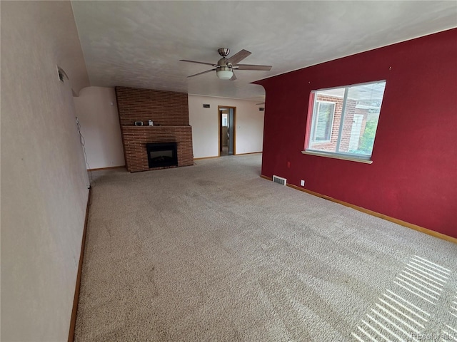 820 Walnut St, Julesburg, CO 80737 - unfurnished living room featuring ceiling fan, carpet floors, baseboards, and a fireplace
