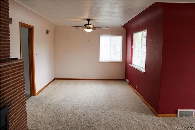 820 Walnut St, Julesburg, CO 80737 - unfurnished room featuring carpet, ceiling fan, baseboards, and a brick fireplace