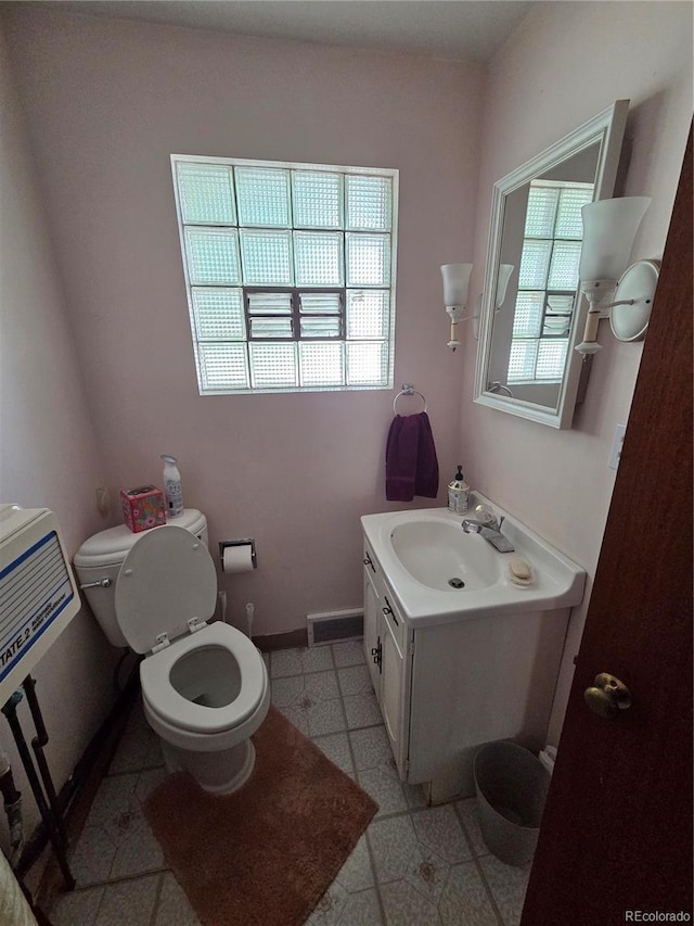 820 Walnut St, Julesburg, CO 80737 - half bath featuring toilet, healthy amount of natural light, baseboards, and vanity