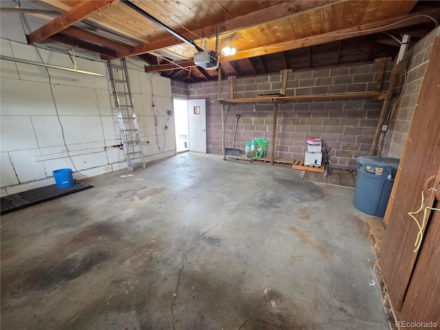820 Walnut St, Julesburg, CO 80737 - garage featuring a garage door opener and concrete block wall