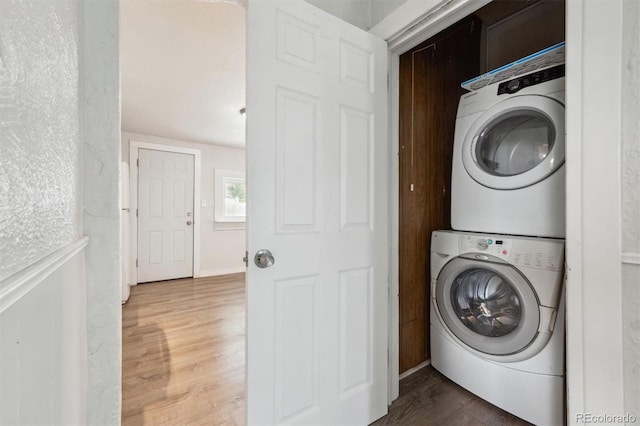4046 S Bannock St, Englewood, CO 80110 - laundry room featuring stacked washing maching and dryer, wood finished floors, and laundry area