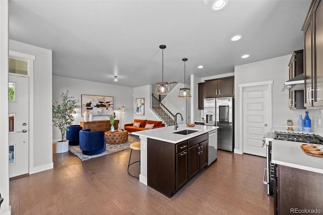 6700 Clay St, Denver, CO 80221 - kitchen with dark brown cabinets, open floor plan, appliances with stainless steel finishes, an island with sink, and dark wood-style flooring