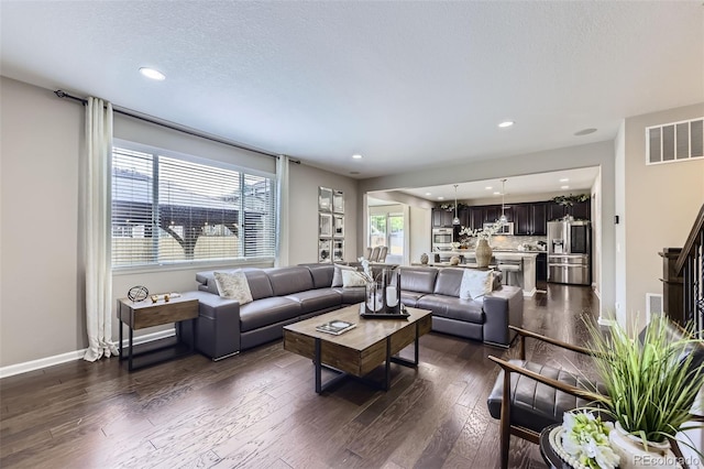 12631 Glencoe St, Thornton, CO 80241 - living room featuring dark wood-style flooring, recessed lighting, and a textured ceiling
