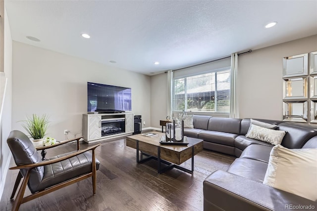 12631 Glencoe St, Thornton, CO 80241 - living room featuring dark wood finished floors, recessed lighting, and a glass covered fireplace