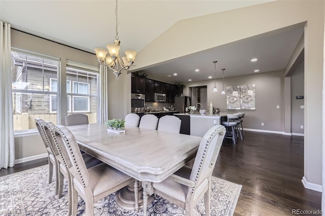 12631 Glencoe St, Thornton, CO 80241 - dining area featuring a chandelier, vaulted ceiling, dark wood-style floors, and recessed lighting