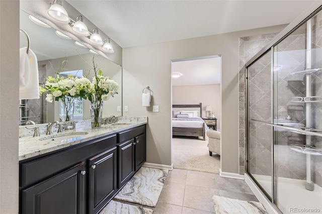 12631 Glencoe St, Thornton, CO 80241 - ensuite bathroom featuring double vanity, a stall shower, tile patterned flooring, and plenty of natural light