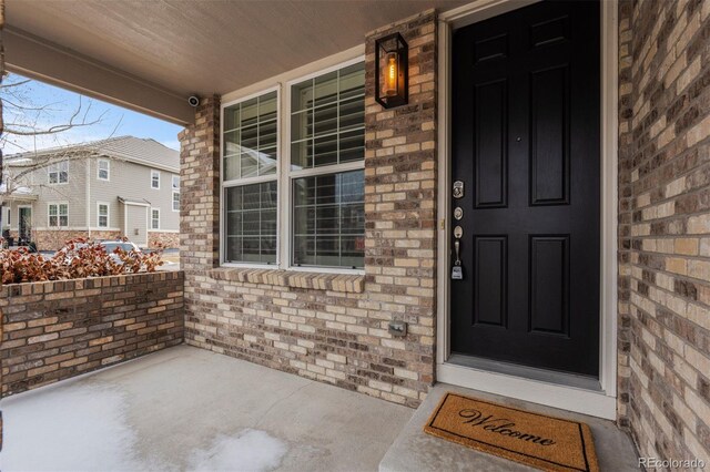 property entrance featuring brick siding