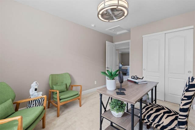 office with attic access, light carpet, and baseboards